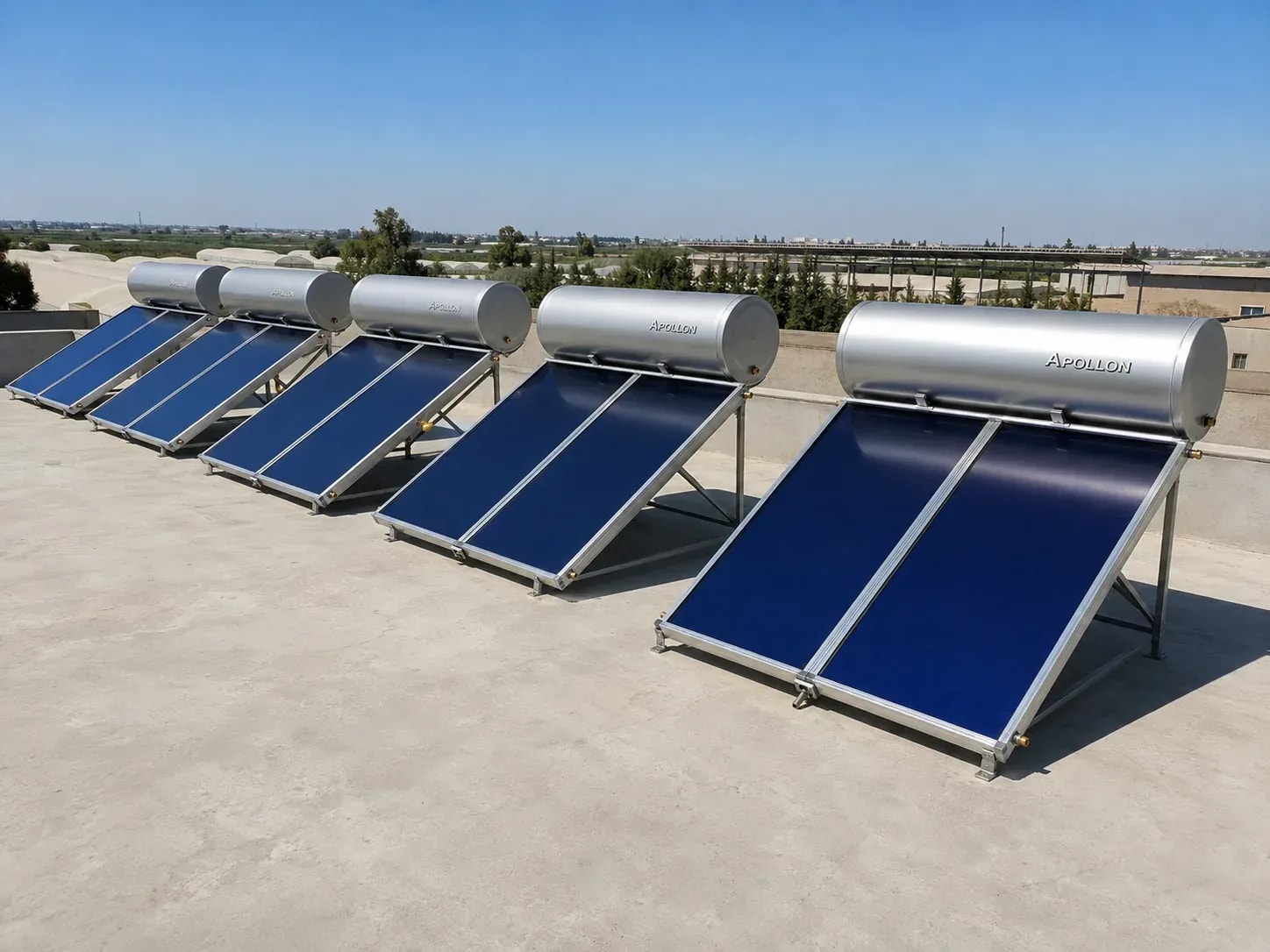 A row of Apollon heaters on a rooftop with trees behind
